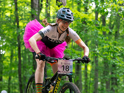 woman in a tutu riding in a mountain bike race
