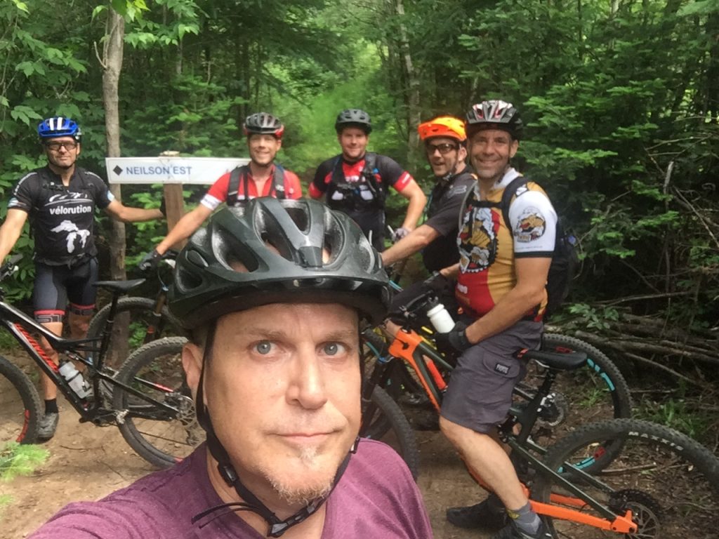 Group shot of Mountain bikers at the entrance to Nielson Nord